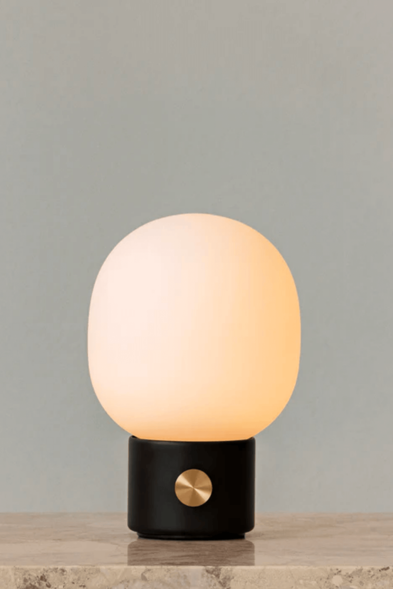 Black Portable JWDA Table Lamp by Menu, shown lit