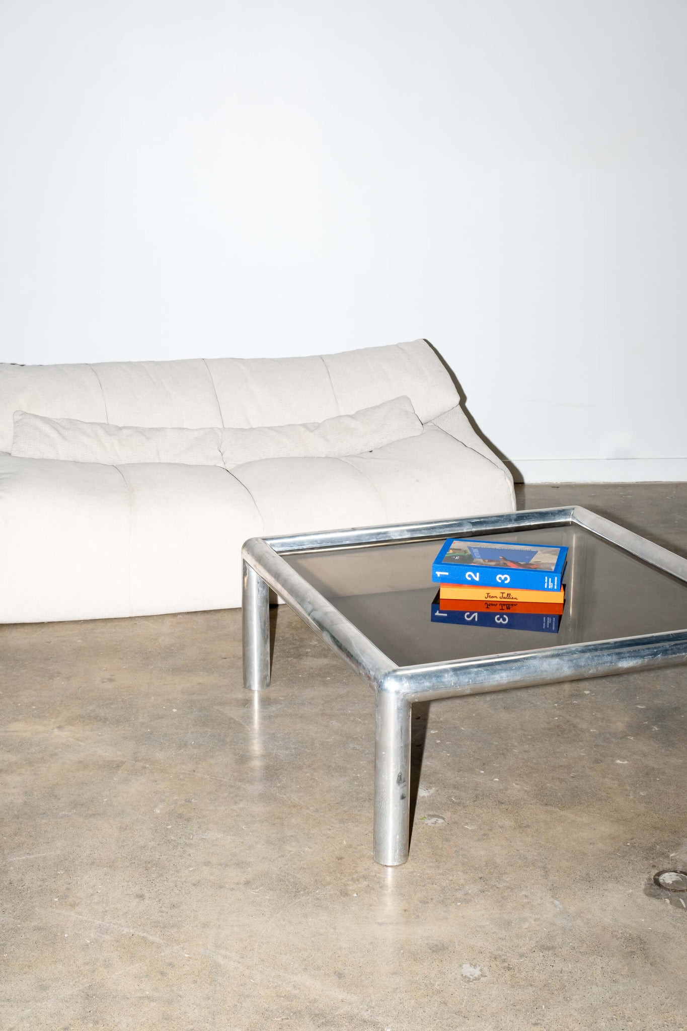 Vintage Cream Cinna Ligne Roset Plumy Sofa, shown with tubular chrome coffee table