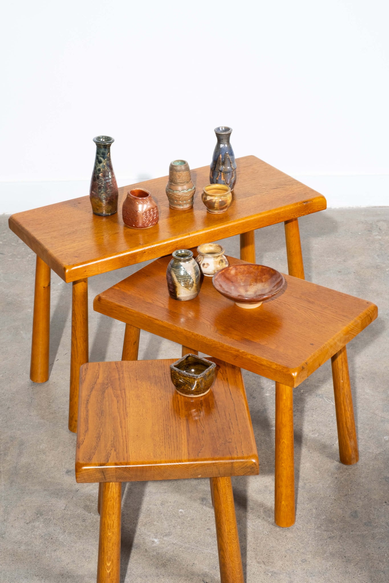 Vintage Oak Nesting Tables with Tapered Legs Set of 3, shown with mini decorative vessels