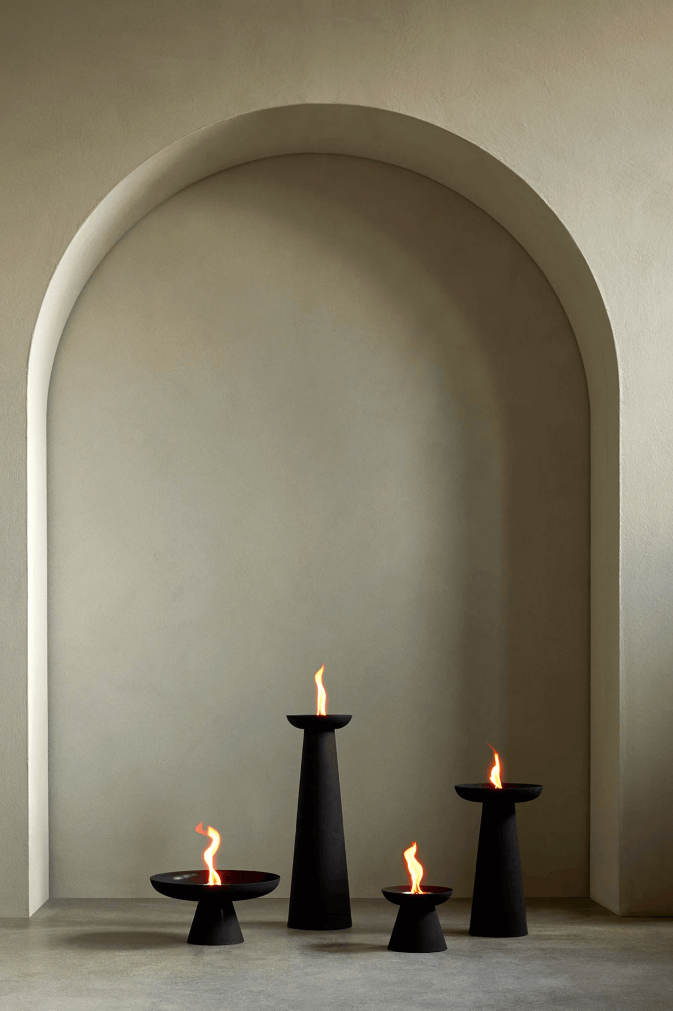 Small Black Meira Oil Lantern by Menu, shown lit in various sizes
