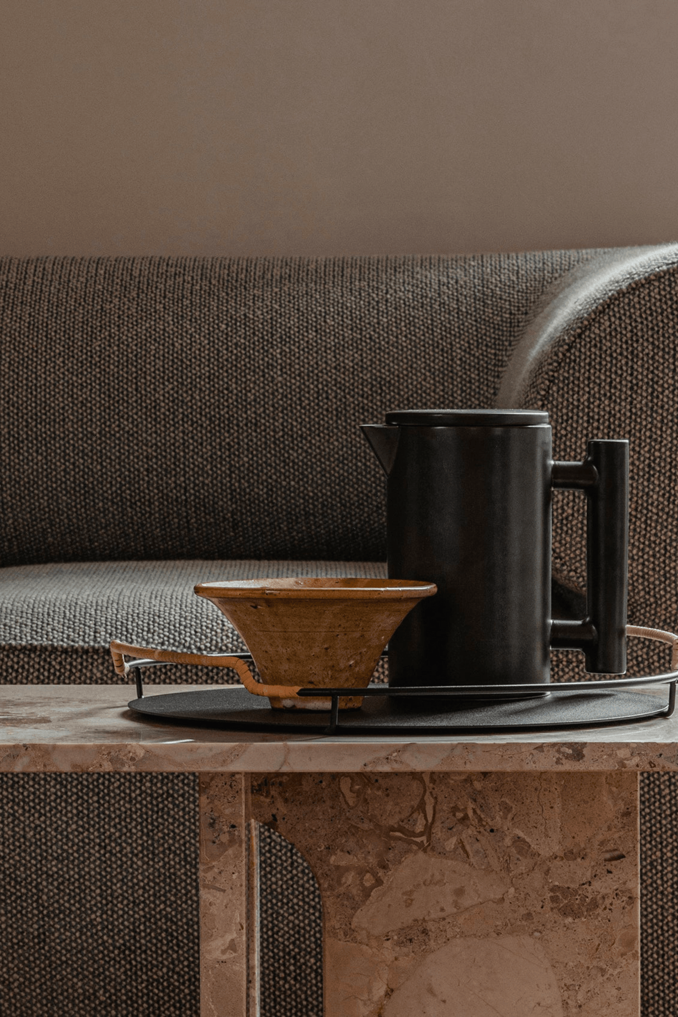 Black Balcony Serving Tray by Menu, shown on coffee table with a carafe and bowl