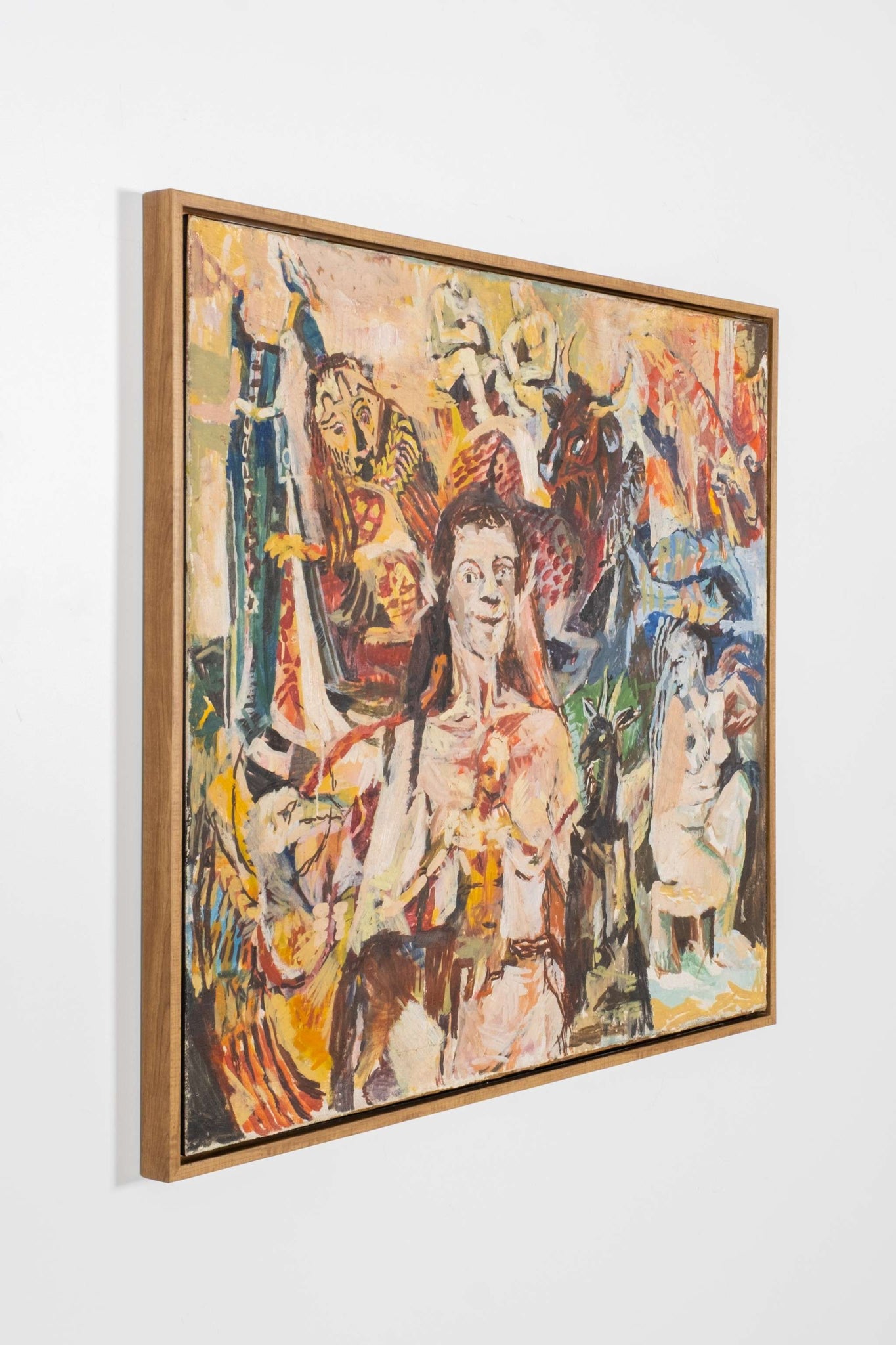 Framed abstract artwork with colorful figures on a white wall