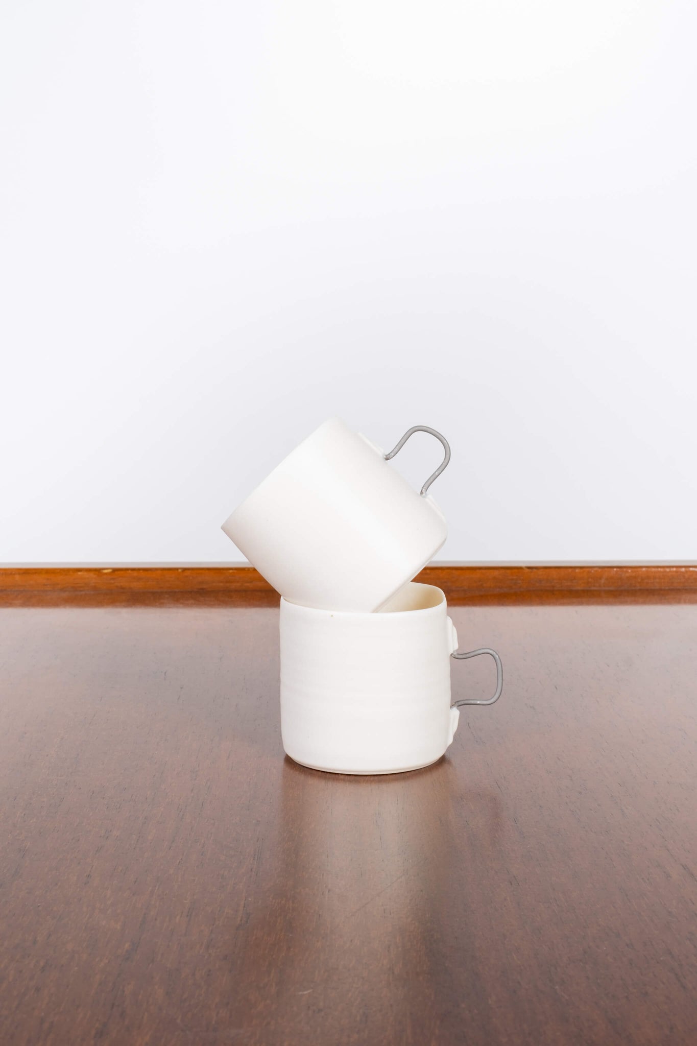 Porcelain Espresso cup with square metal handle, shown stacked