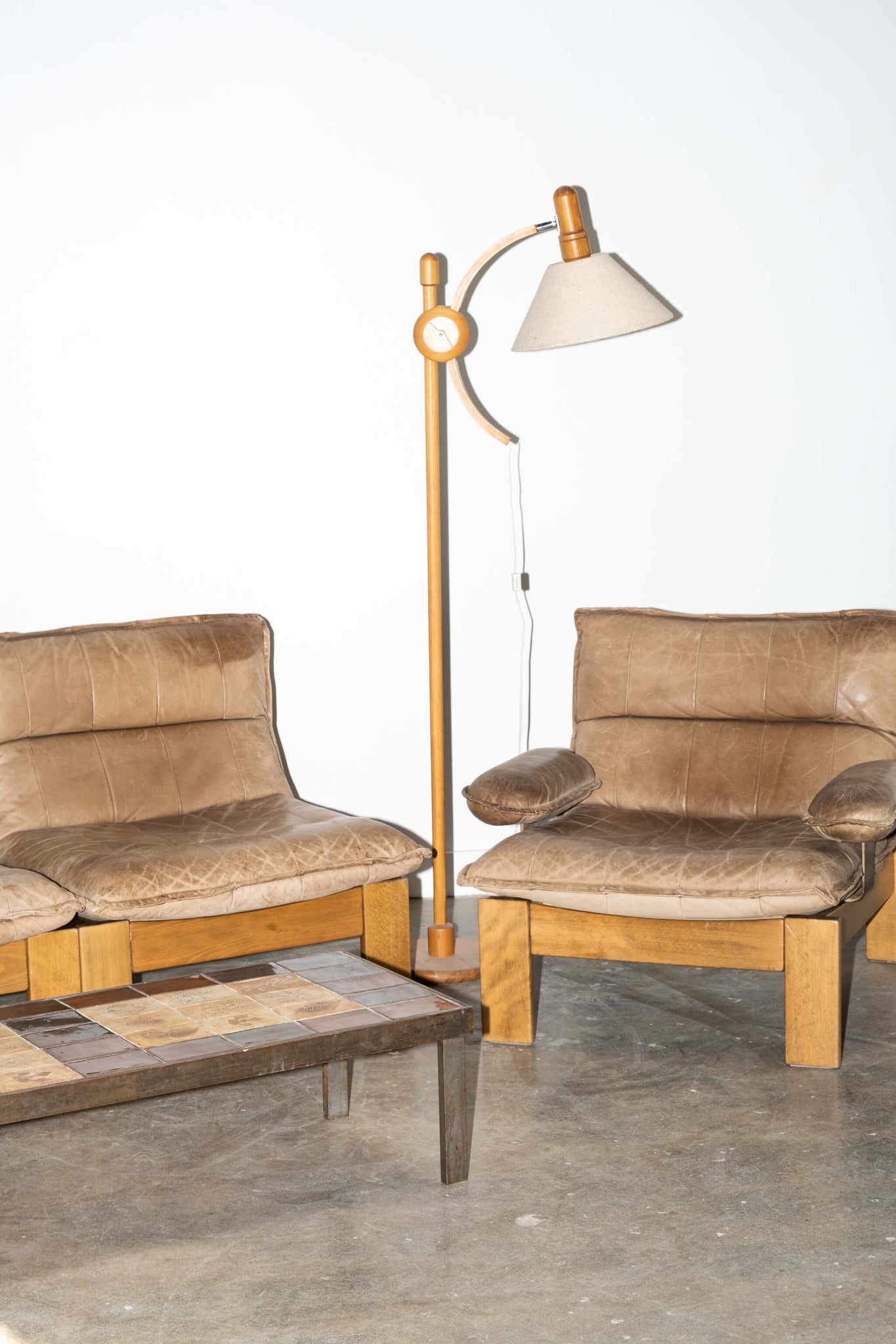 Vintage Arc Pivot Floor Lamp in Pine, shown with tan and wood leather sofa set