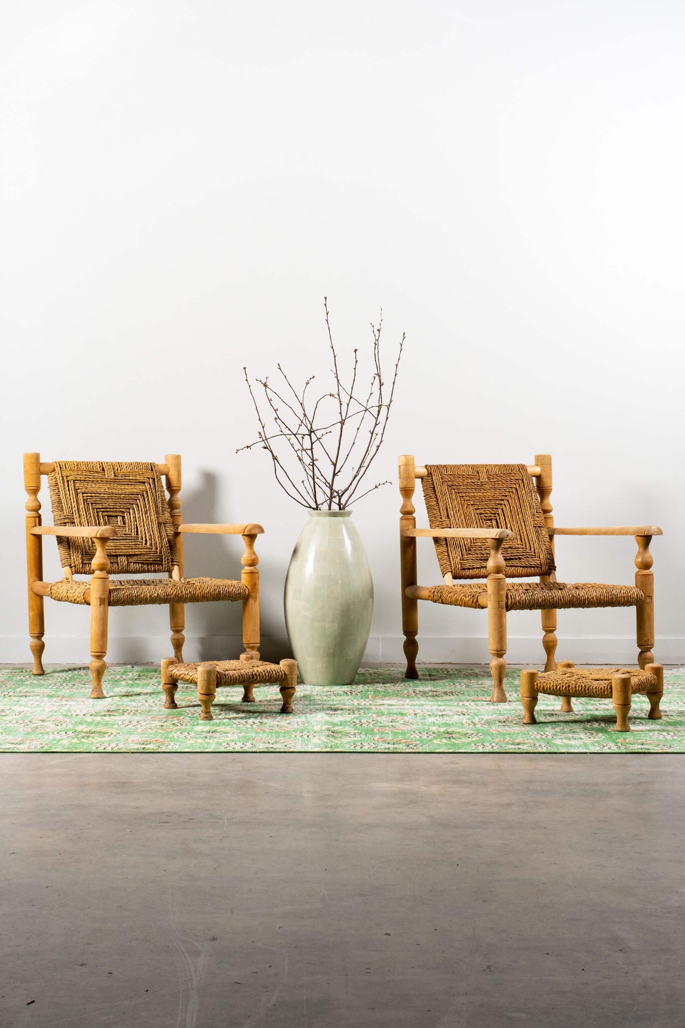 Vintage French Wood and Rope Armchairs with Footstools Adrien Audoux and Frida Minet, shown side by side on rug with floor vase