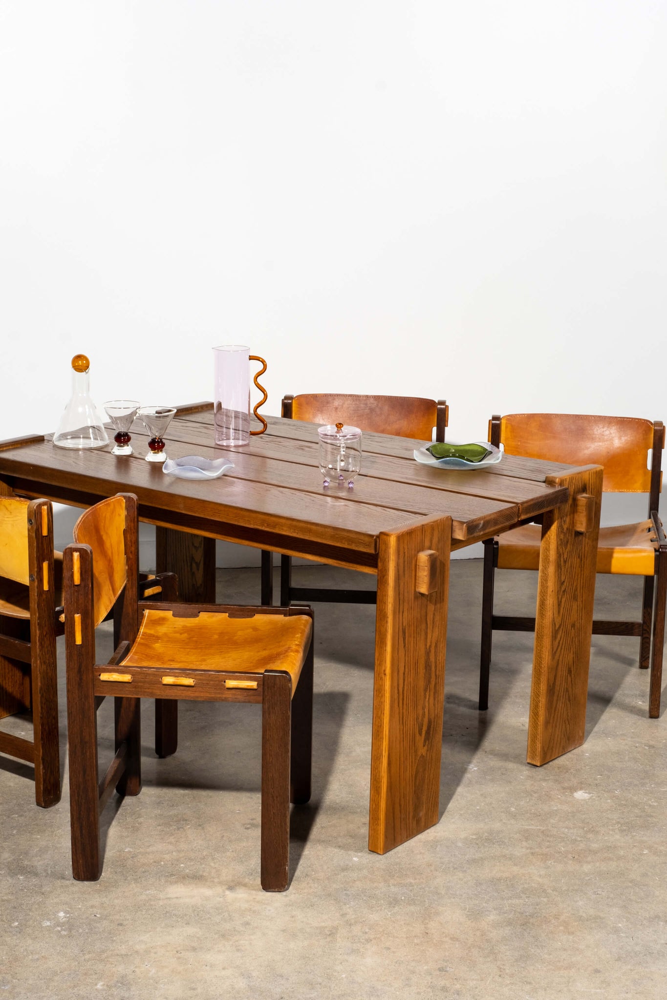 Vintage 1960s French Oak Dining Table, shown with wood and leather chairs and glass serveware