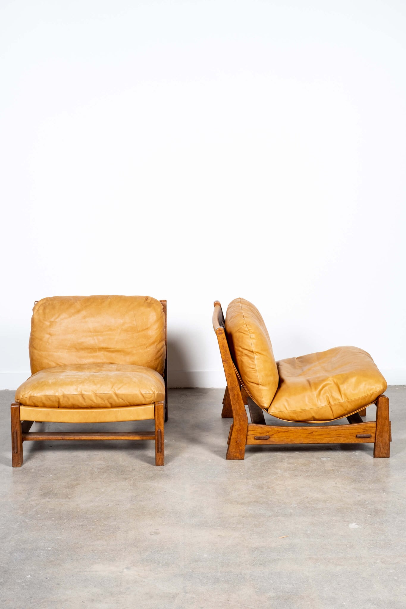 Pair of Vintage Leather Sling Chairs with Oak Frame, front and side view