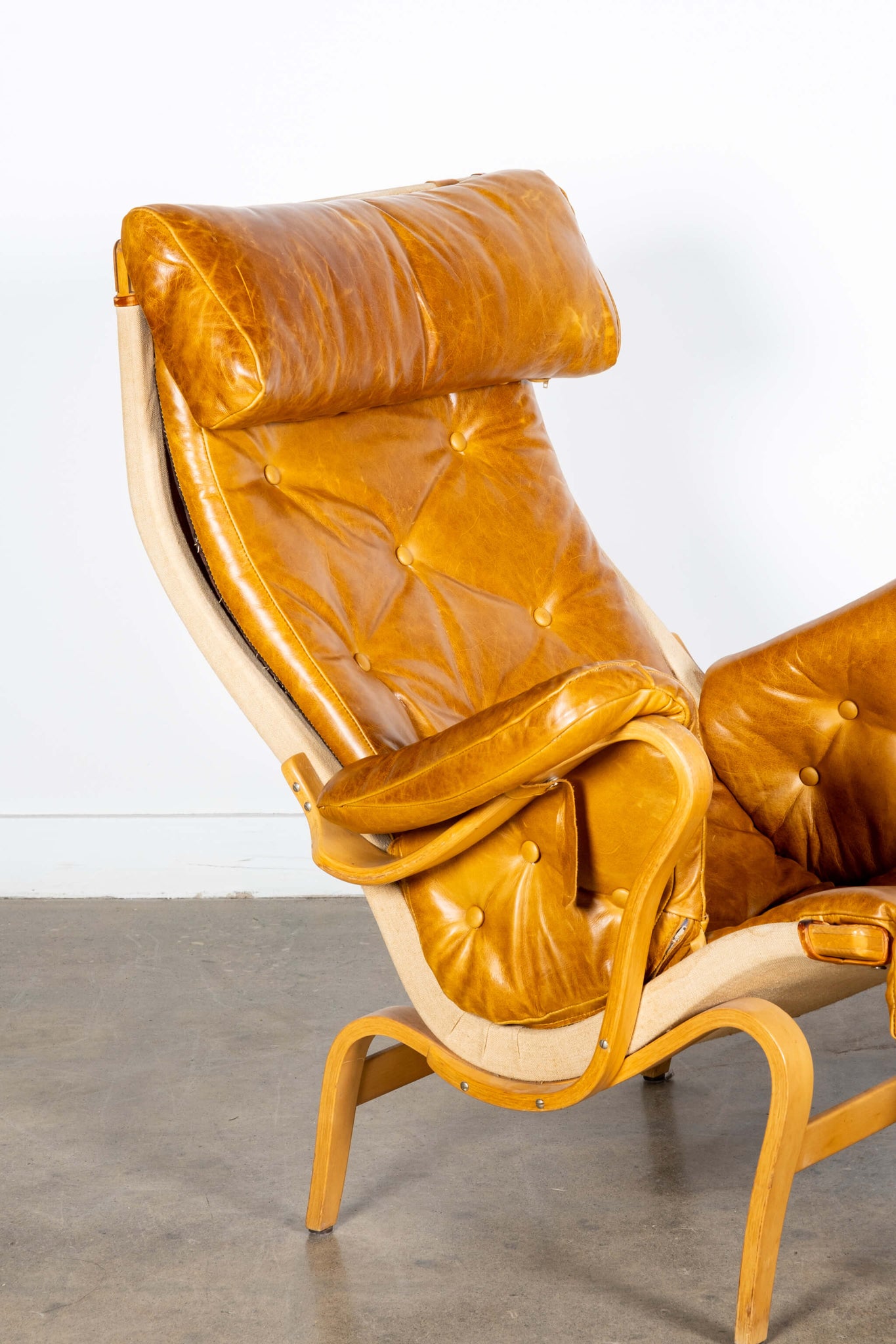 Pernilla 69 Leather and Beech Lounge Chair and Ottoman, close-up angled view